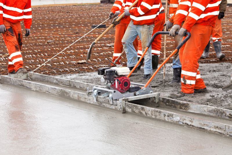 concrete workers smoothing concrete surface